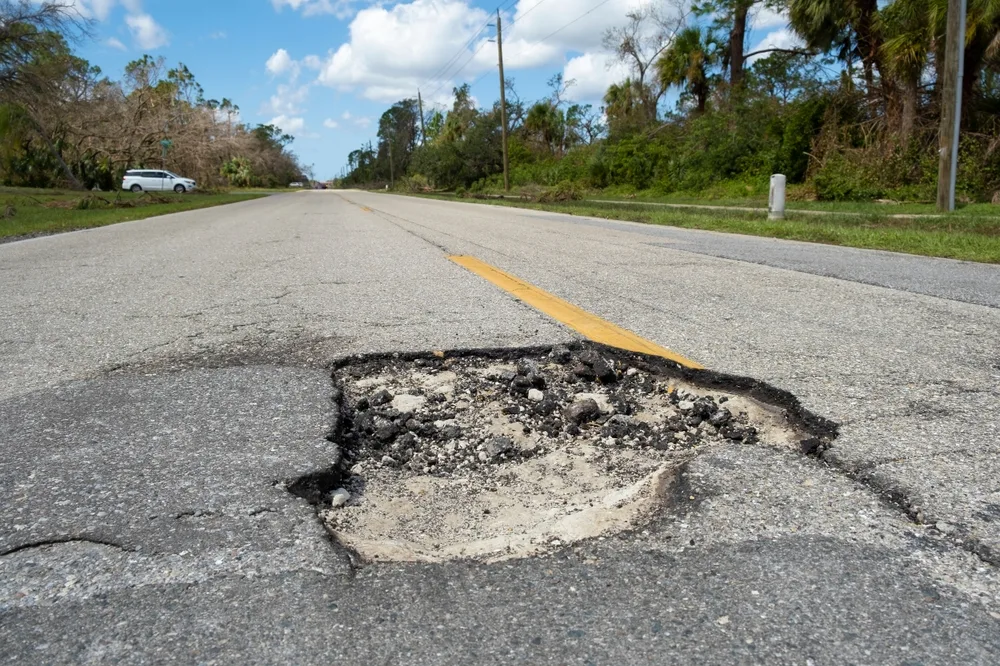 Read more about the article How Do Potholes Form and What Causes Them?