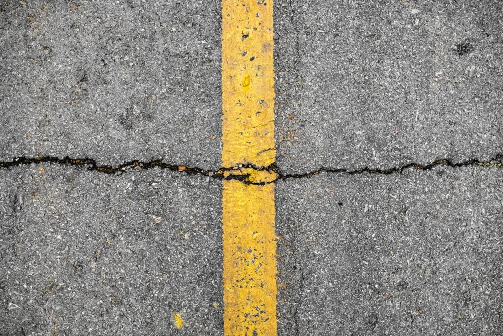 Asphalt crack on line yellow on road before asphalt crack repair/crackfilling job
