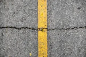 Asphalt crack on line yellow on road before asphalt crack repair/crackfilling job