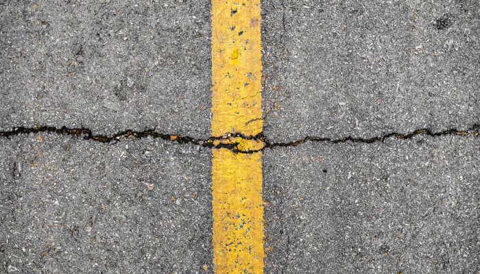 Asphalt crack on line yellow on road
