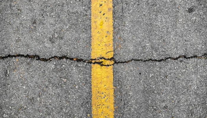 Asphalt crack on line yellow on road before asphalt crack repair job