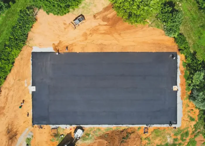 Aerial shot of fresh asphalt being laid down for a brand new sports court