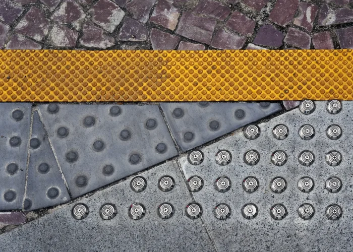 Tactile warning surfaces and detectable paving features designed to improve pedestrian accessibility and ADA compliance.